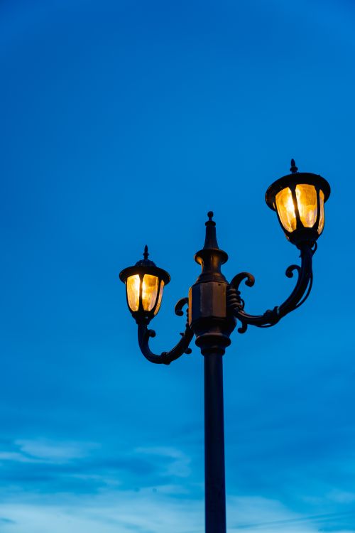 Free A vintage street lamp glows warmly against a vibrant twilight sky in Batticaloa, Sri Lanka. Stock Photo