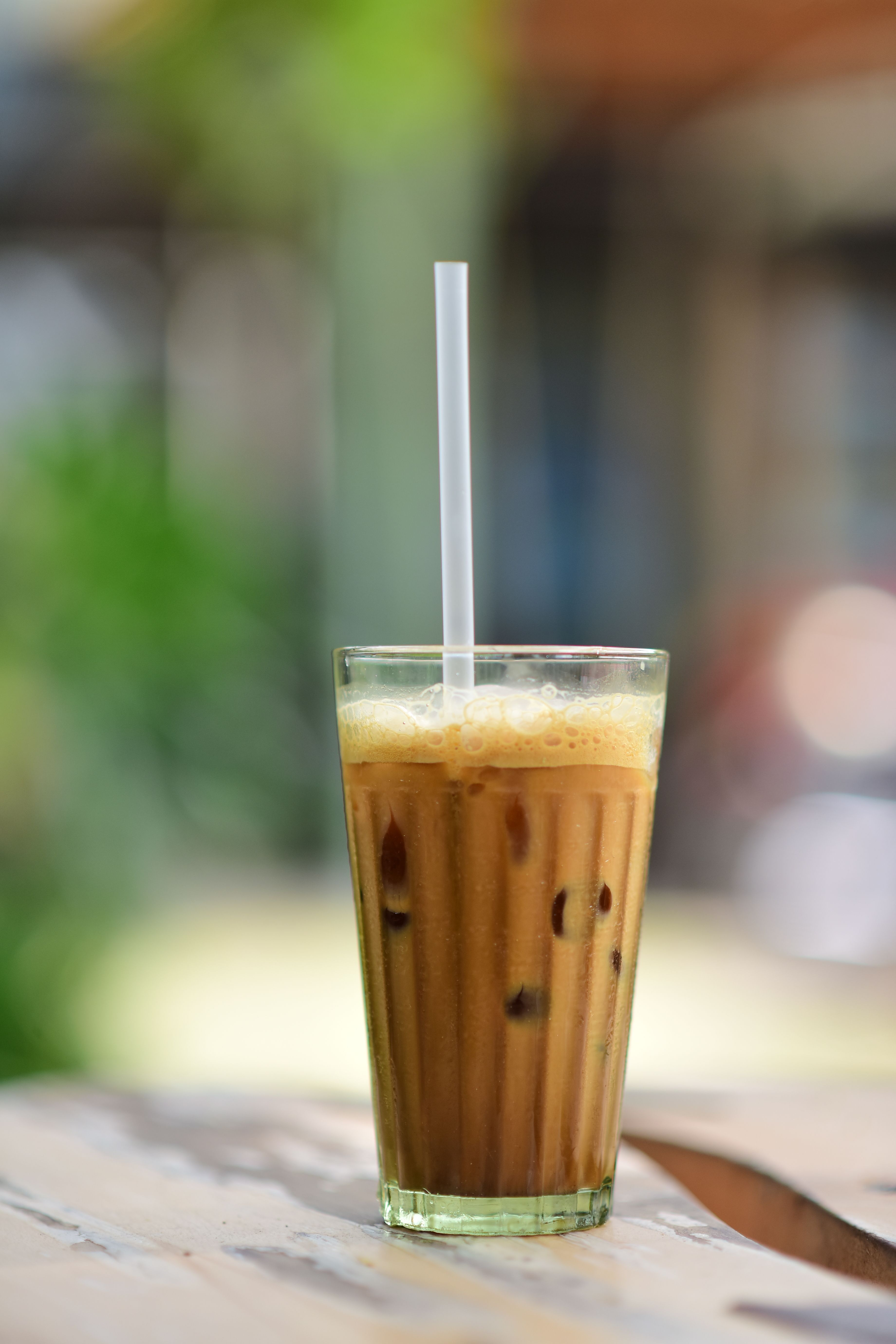 Iced coffee in a glass with a straw, perfect for a summer day.