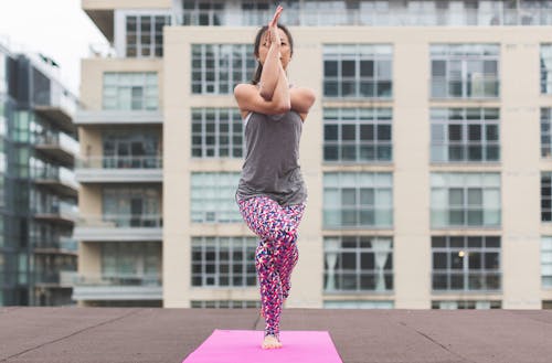 Woman in Gray Top and Pink Pants Yoga on Pink Mat