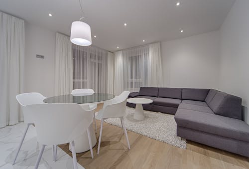 Gray Sectional Couch Beside White Round Table