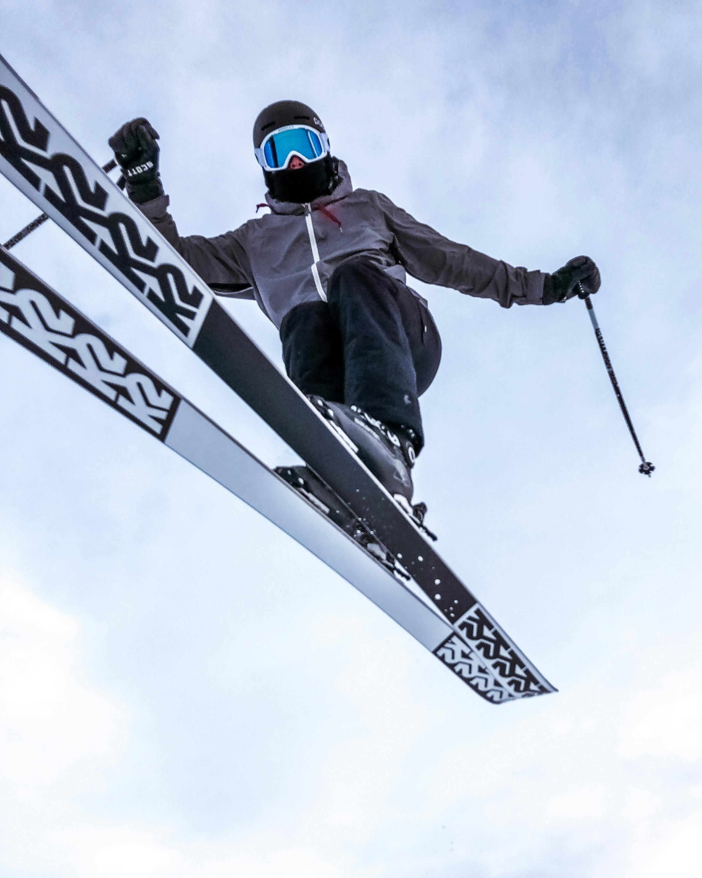 flying skier in jump against blue sky