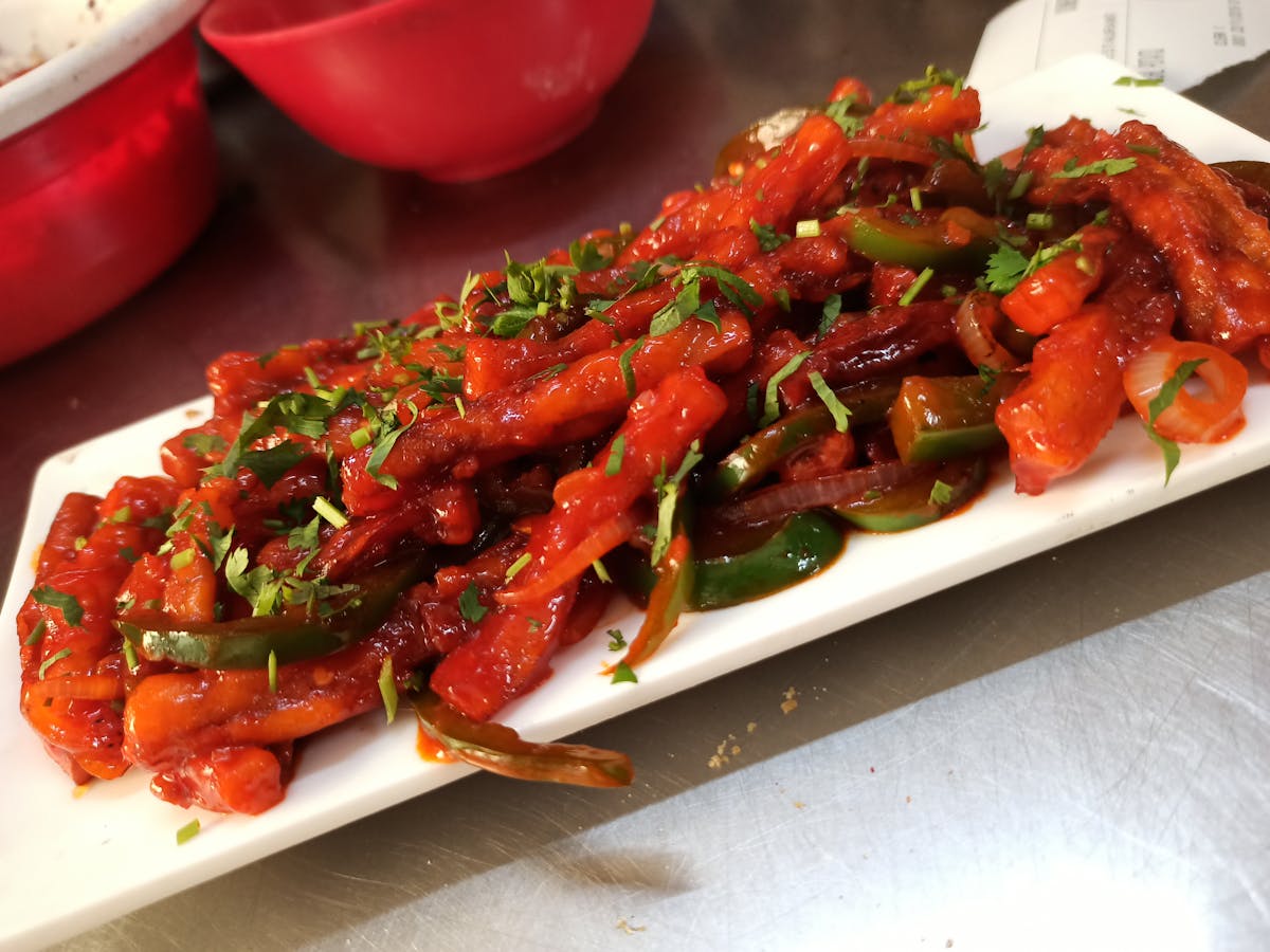 Hands holding a warm mug of latte near a window