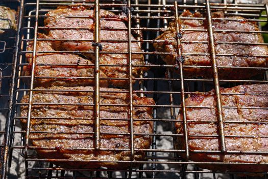 Juicy grilled beef steaks sizzling on a barbecue in Coesfeld, Germany.