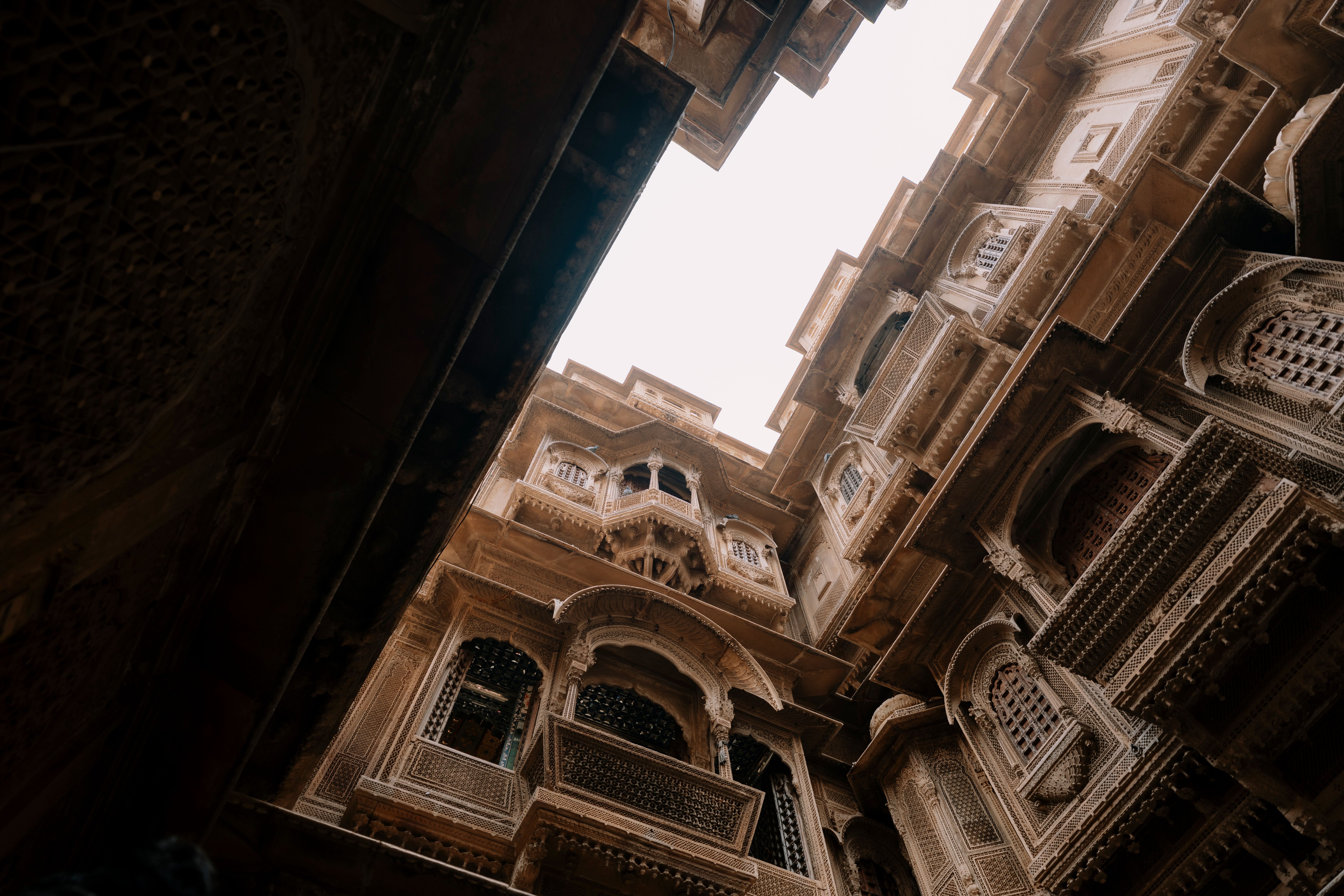Intricately carved sandstone facade of a historic Jaisalmer haveli in warm heritage-brown tones