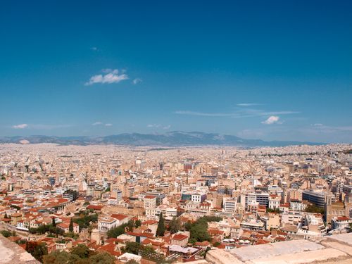 Free Expansive aerial view of Athens with historic architecture under a clear summer sky. Stock Photo