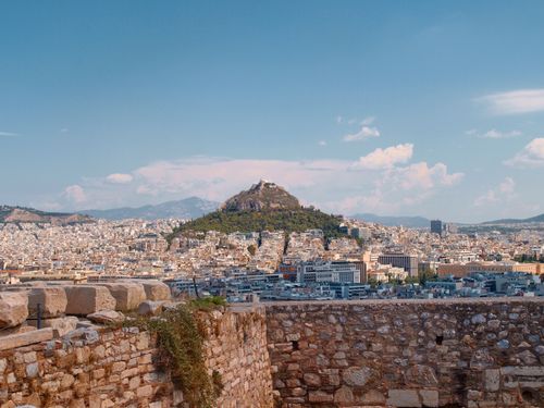 Free A panoramic cityscape of Athens featuring Mount Lycabettus, captured from the Acropolis under a clear summer sky. Stock Photo