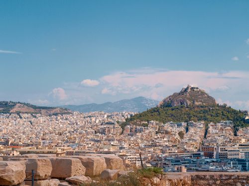 Free Panoramic view of Athens cityscape with Mount Lycabettus in the background under a clear summer sky. Stock Photo