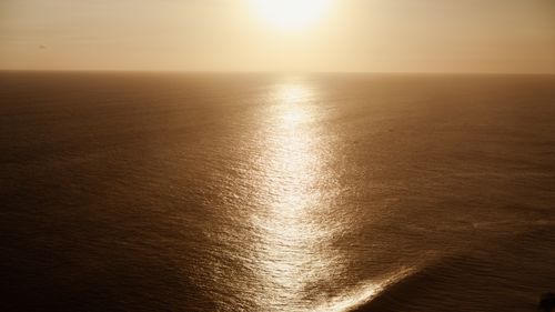 Free A breathtaking view of the golden sunset reflecting off the ocean near Bali, Indonesia. Stock Photo