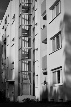 Black and white photo of a modern residential building with balconies