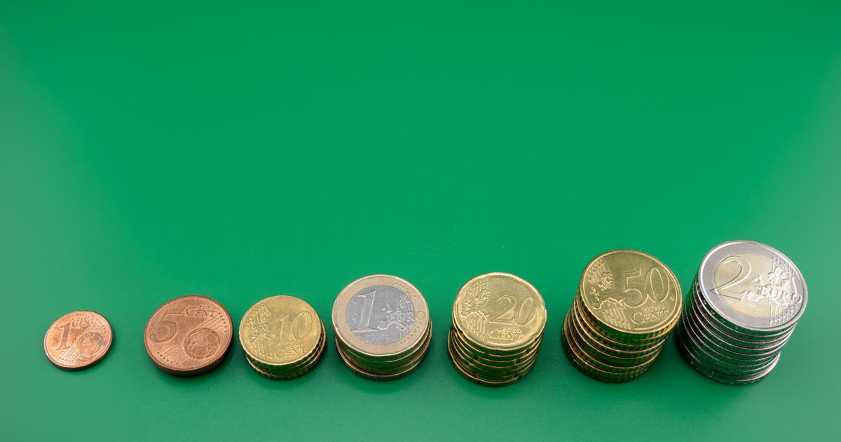 Various euro coins stacked incrementally on a vibrant green background.