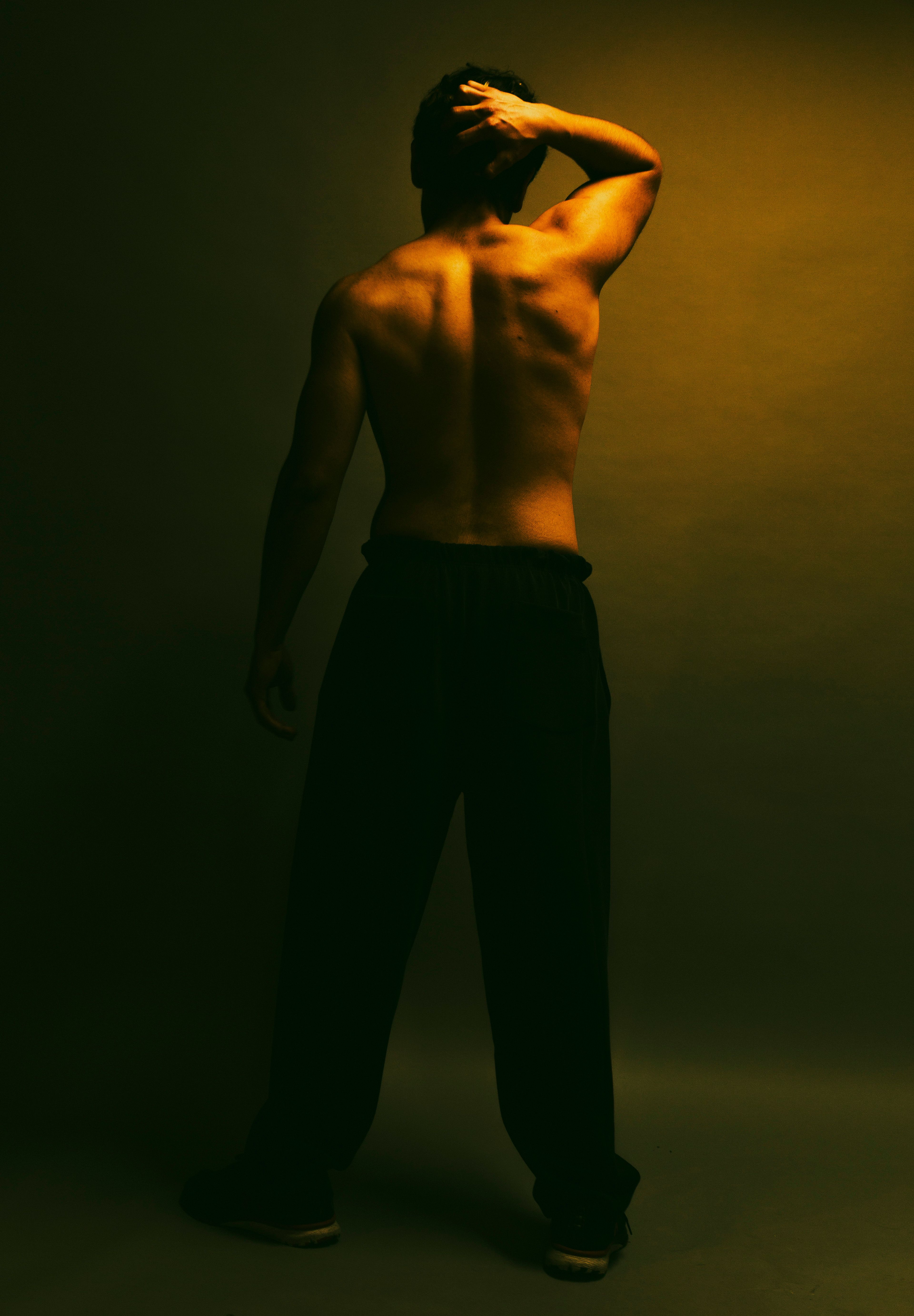 Dramatic Male Back Pose in Artistic Lighting · Free Stock Photo