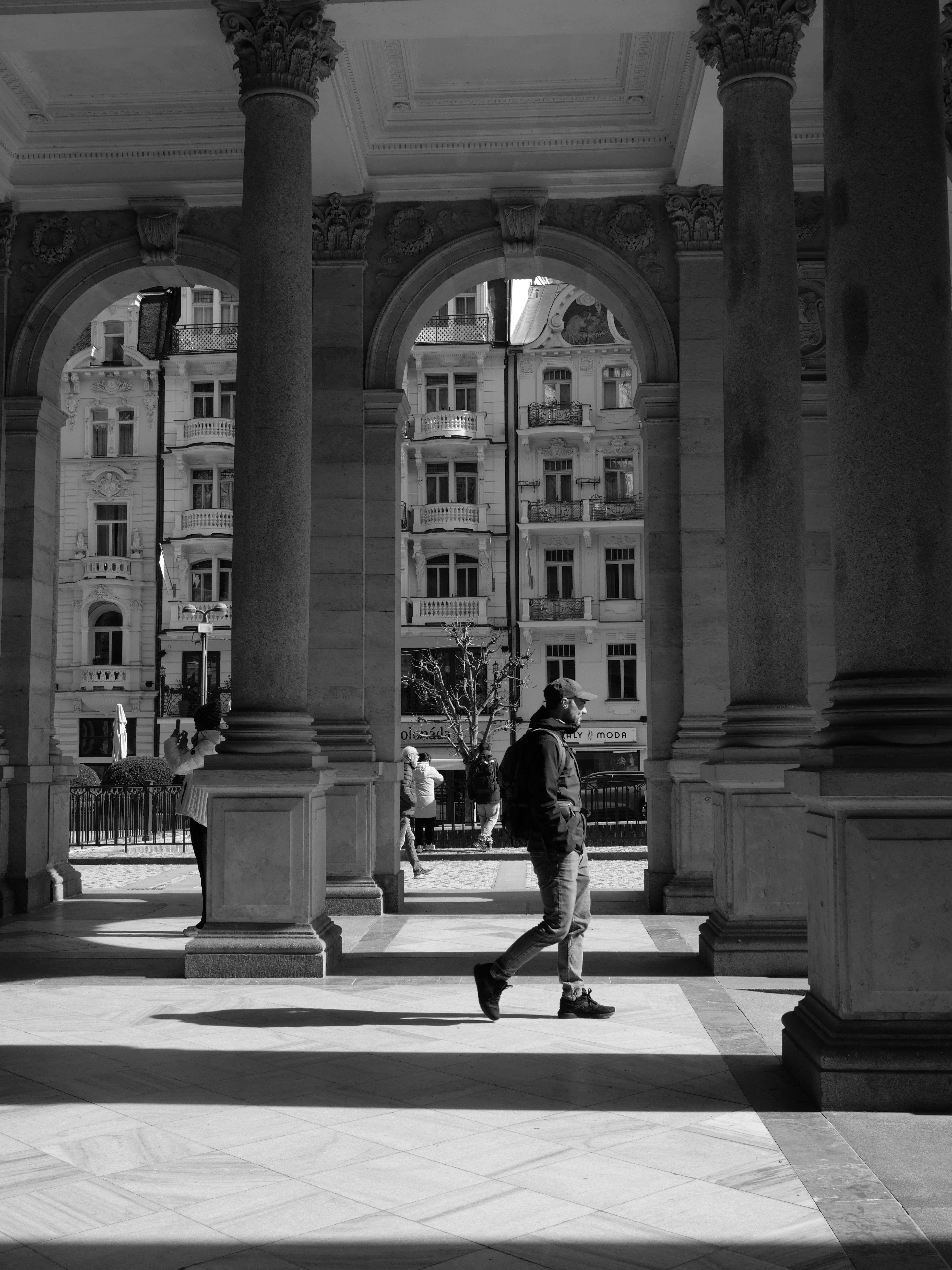 Monochrome Urban Scene with Arched Columns · Free Stock Photo