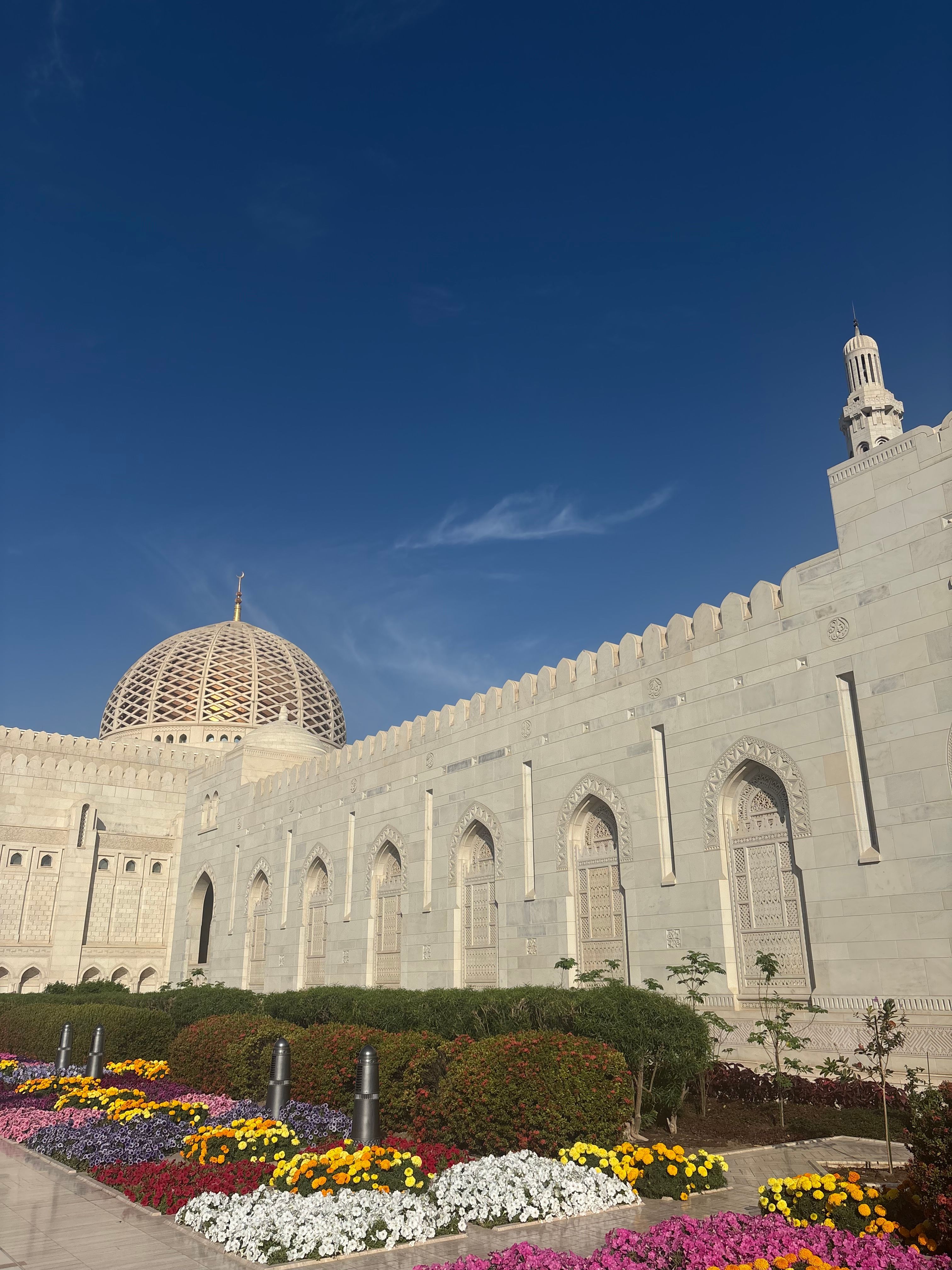 The breathtaking traditional architecture of the Sultan Qaboos Grand Mosque in Muscat Oman for a unique Umrah stopover