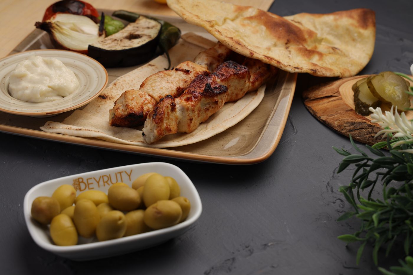 Lebanese Shish Tawook with sides, showcasing authentic Middle Eastern cuisine.