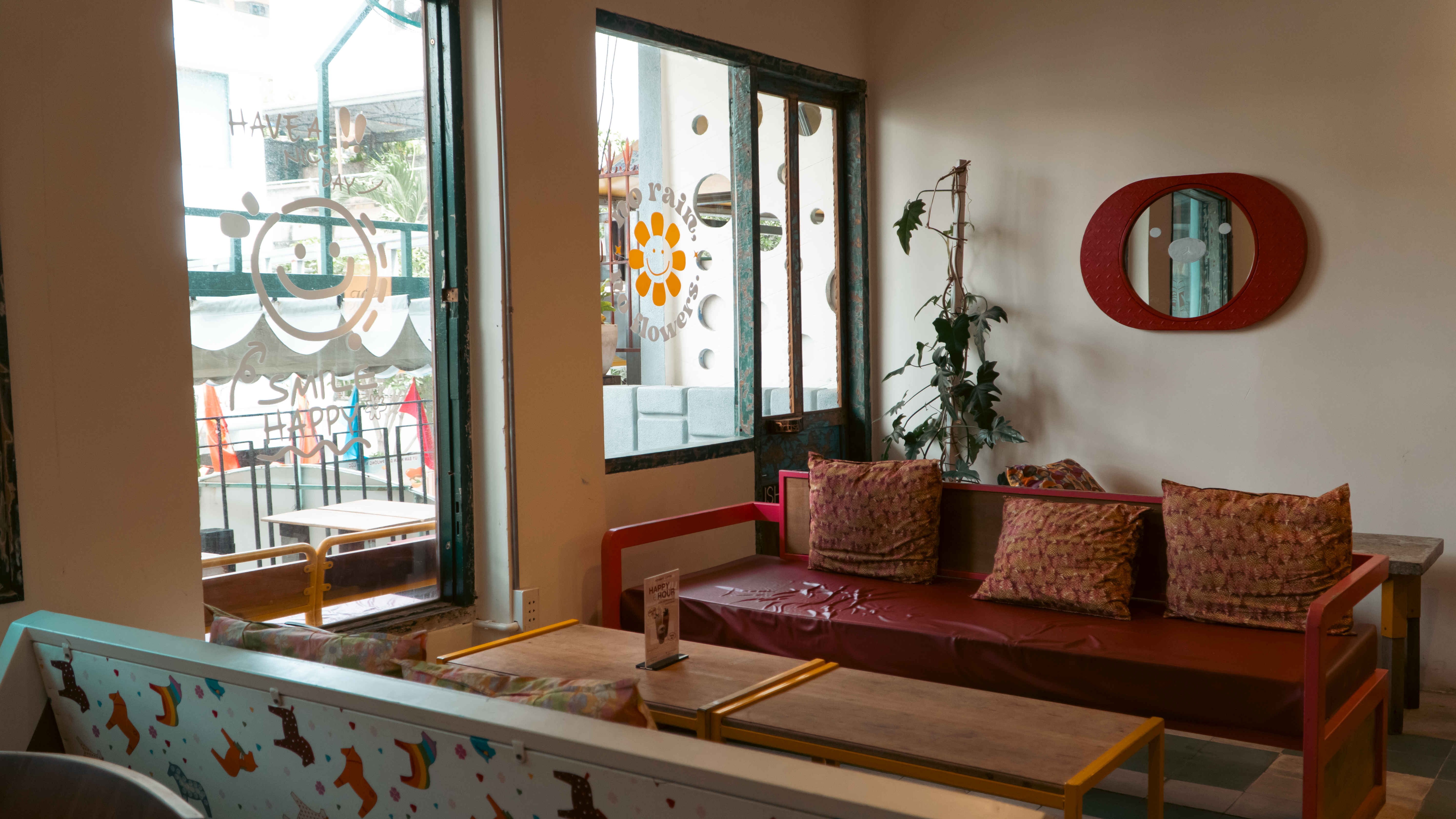 Inviting café interior with cozy seating, vibrant pillows, and decorative elements