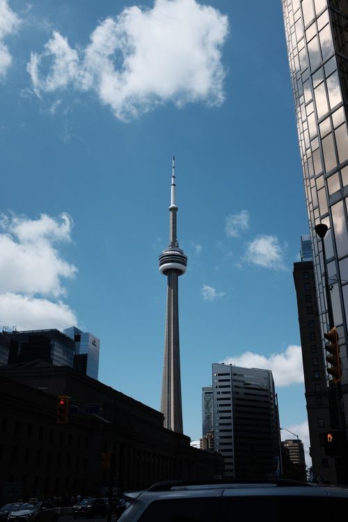Free Iconic CN Tower captured on a clear day with surrounding skyscrapers in downtown Toronto. Stock Photo