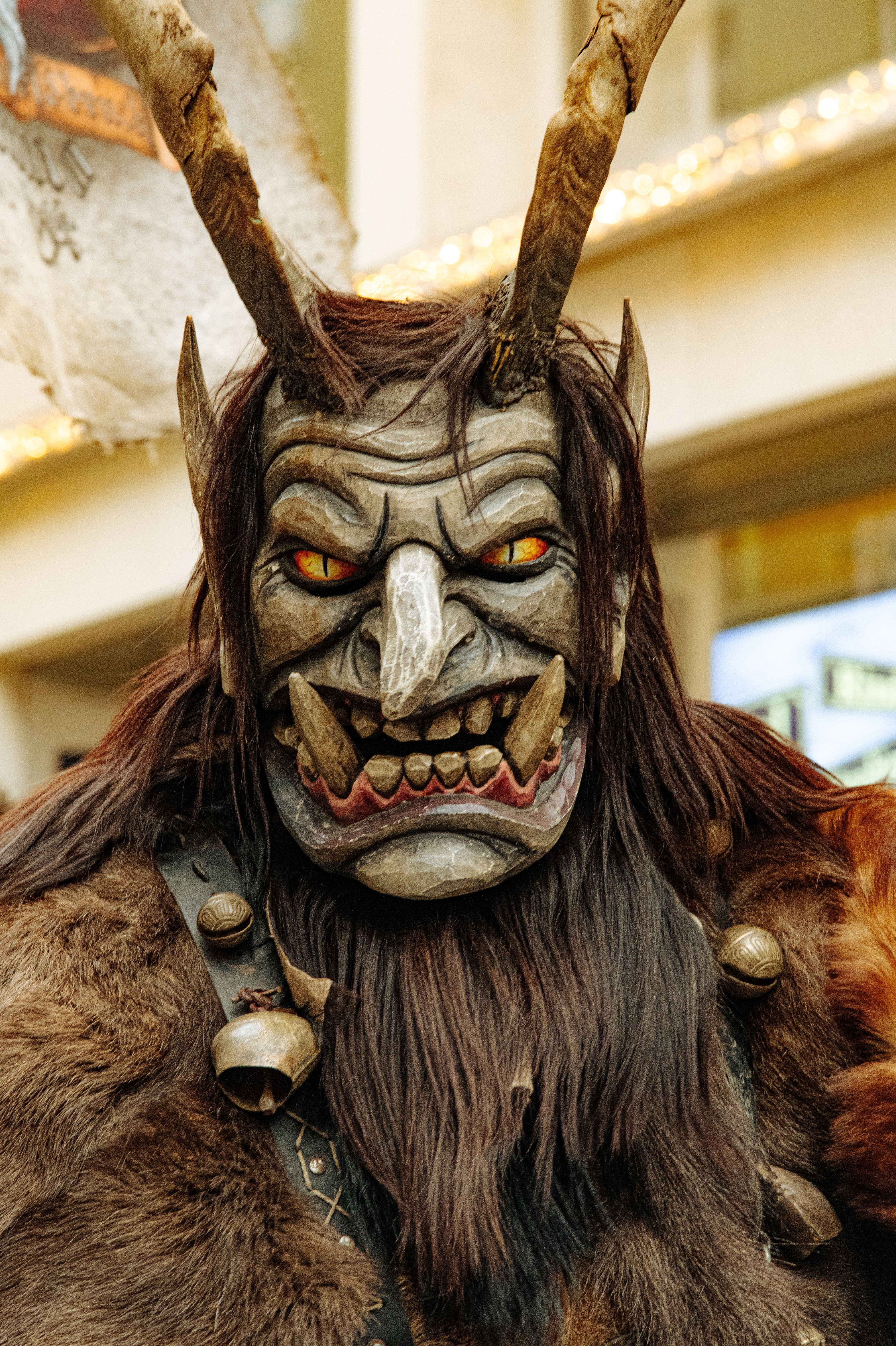 Close-up of a Krampus costume with horns, fangs, and fur.