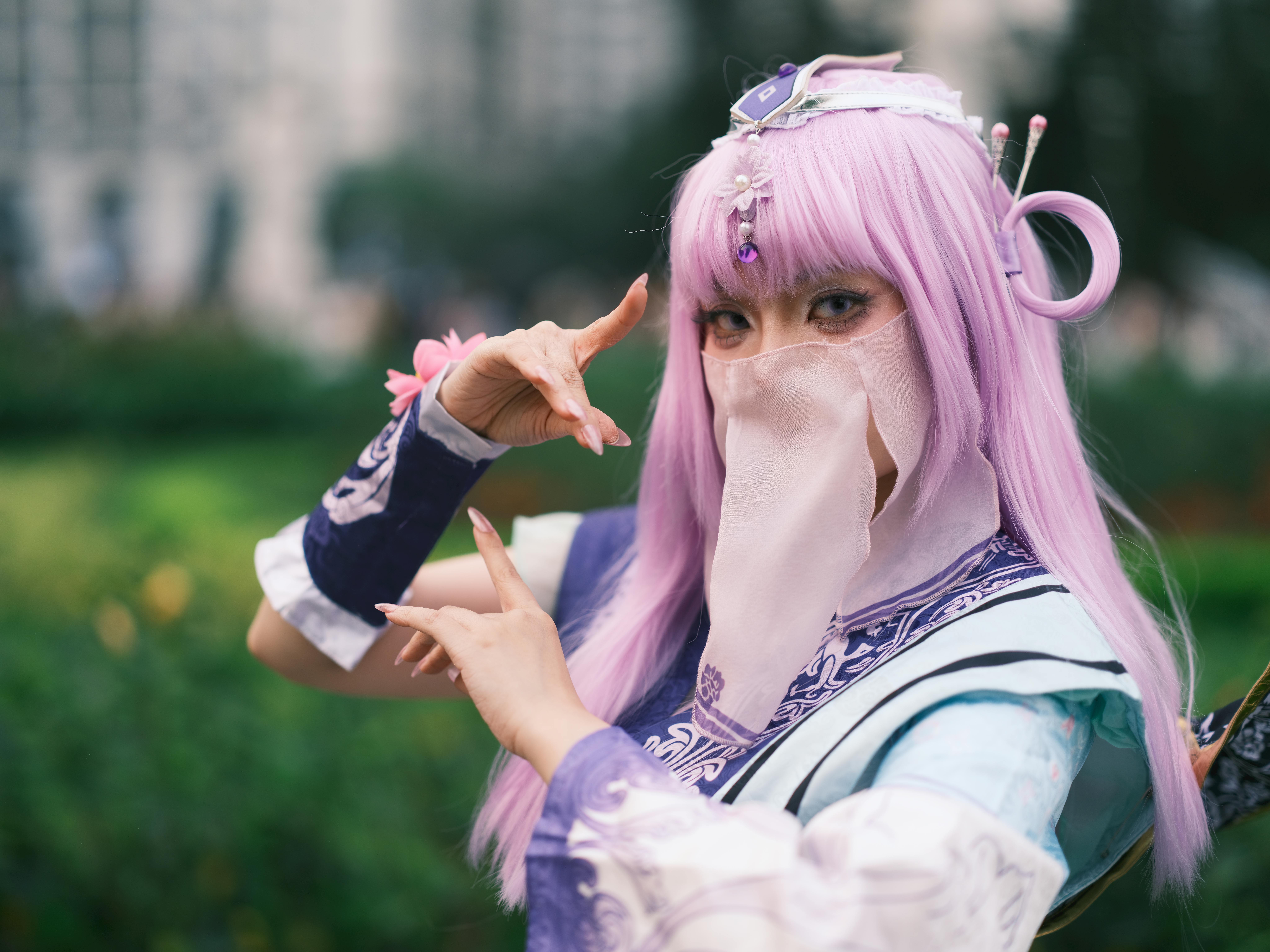 Captivating cosplay character in a vibrant costume with purple hair, set outdoors in Vietnam.
