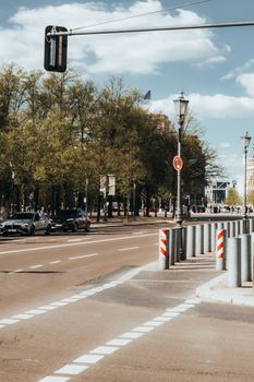Explore a sunlit street in Berlin, Germany, capturing urban life with dramatic lighting and minimalistic appeal.