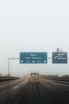 A misty road scene on an autobahn leading to Berlin, perfect for travel and urban themes.