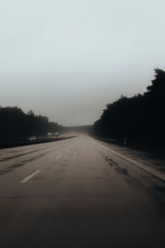 Dramatic foggy view of an empty highway in Berlin, Germany.
