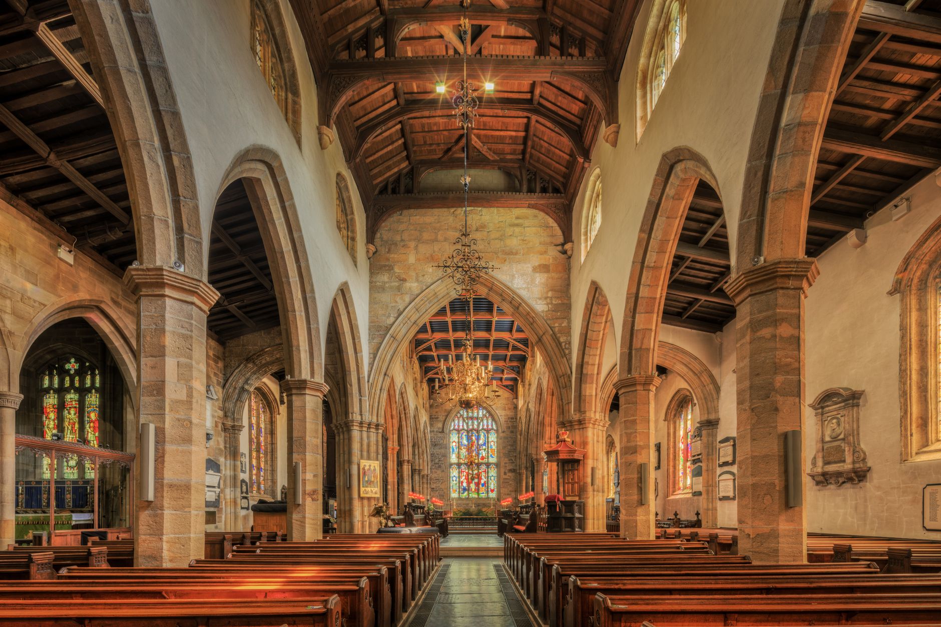 A beautifully detailed view of the nave inside a historic English church, showcasing gothic architecture.