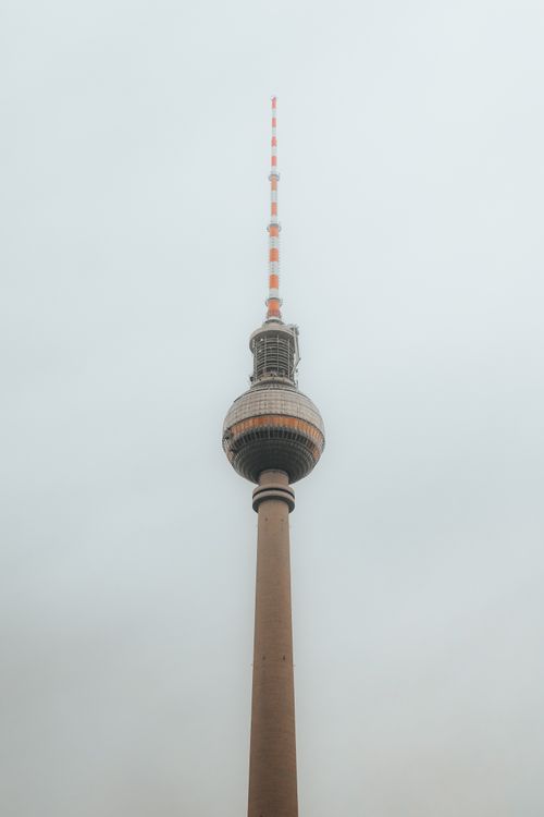 Free The iconic Berlin TV Tower stands tall in a misty, minimalistic scene, showcasing modern architecture. Stock Photo