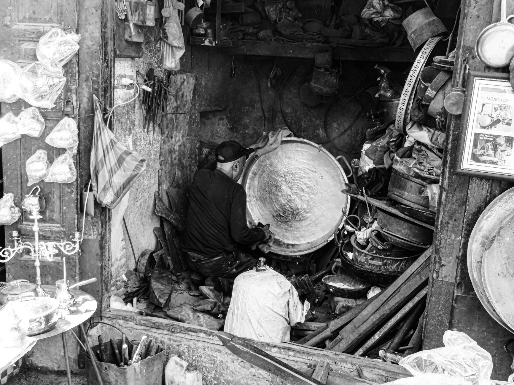 Artisan working in a traditional metal workshop in Fez, Morocco.