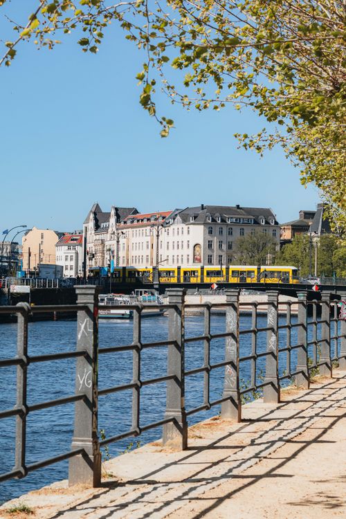 Free Beautiful spring day at a riverside park in Berlin, showcasing urban architecture and vibrant city life. Stock Photo