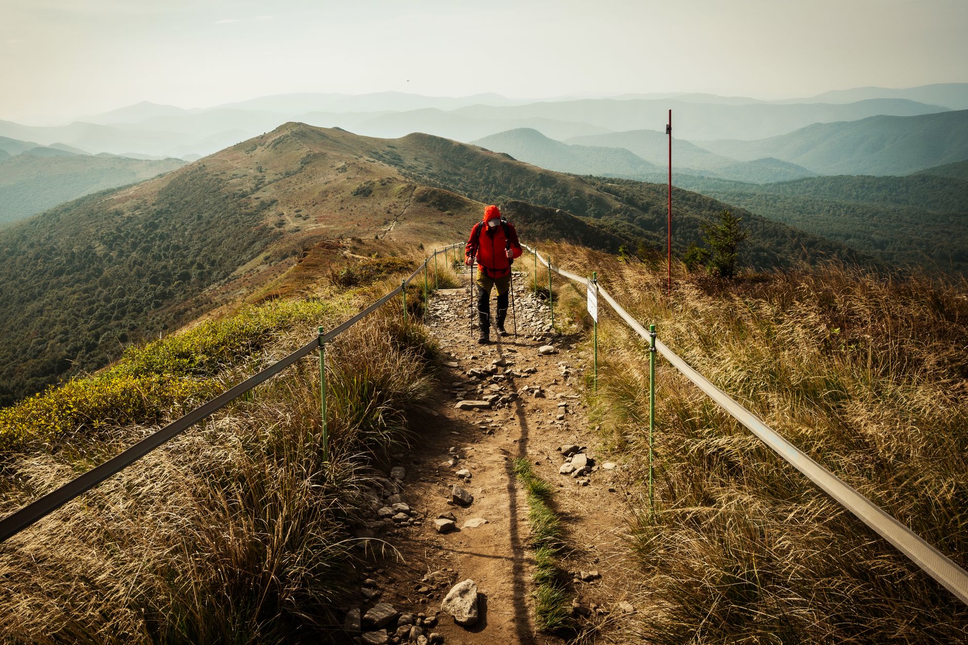 hiker navigating mountain wilderness trail