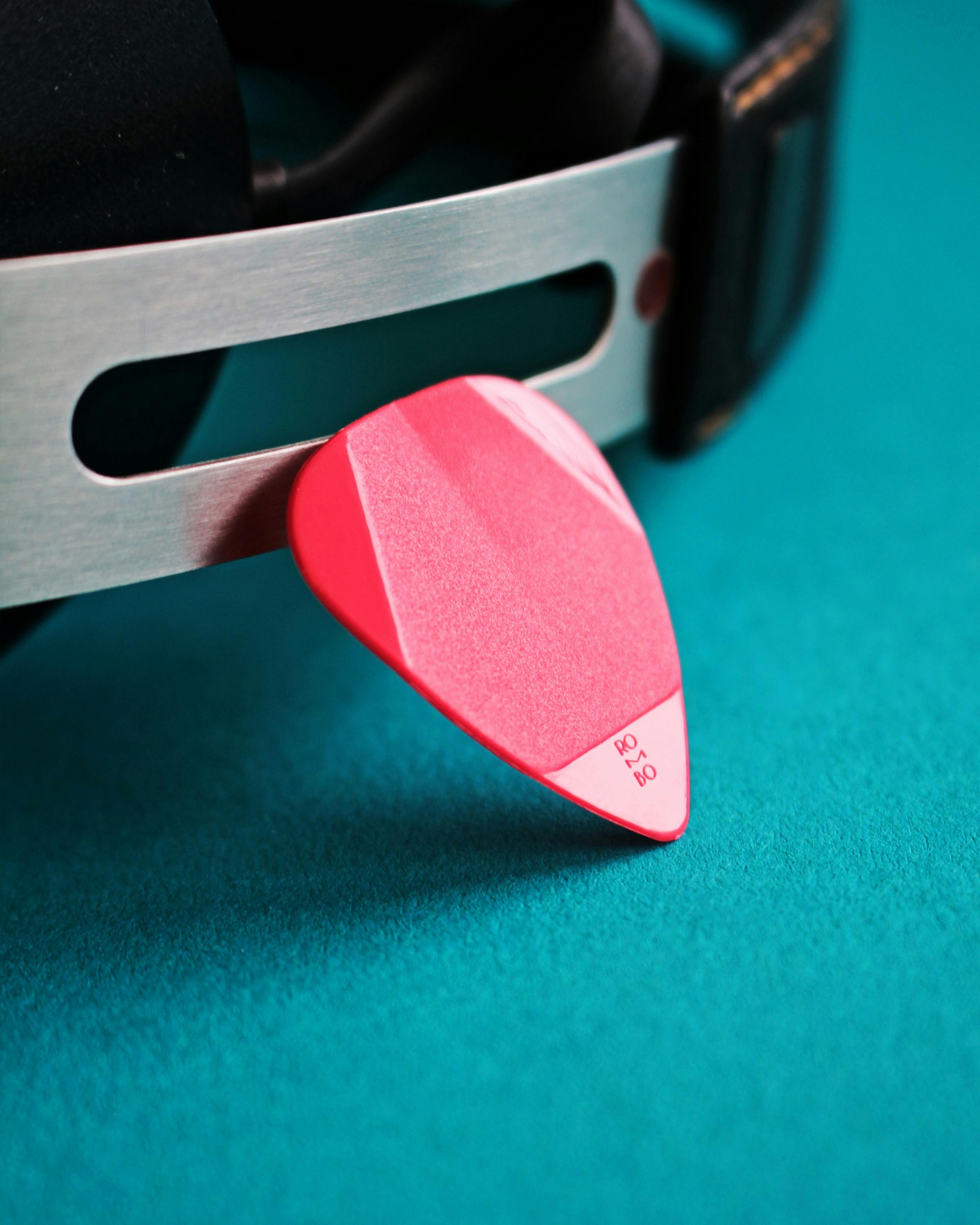 Close Up Photo of a Red Guitar Pick · Free Stock Photo