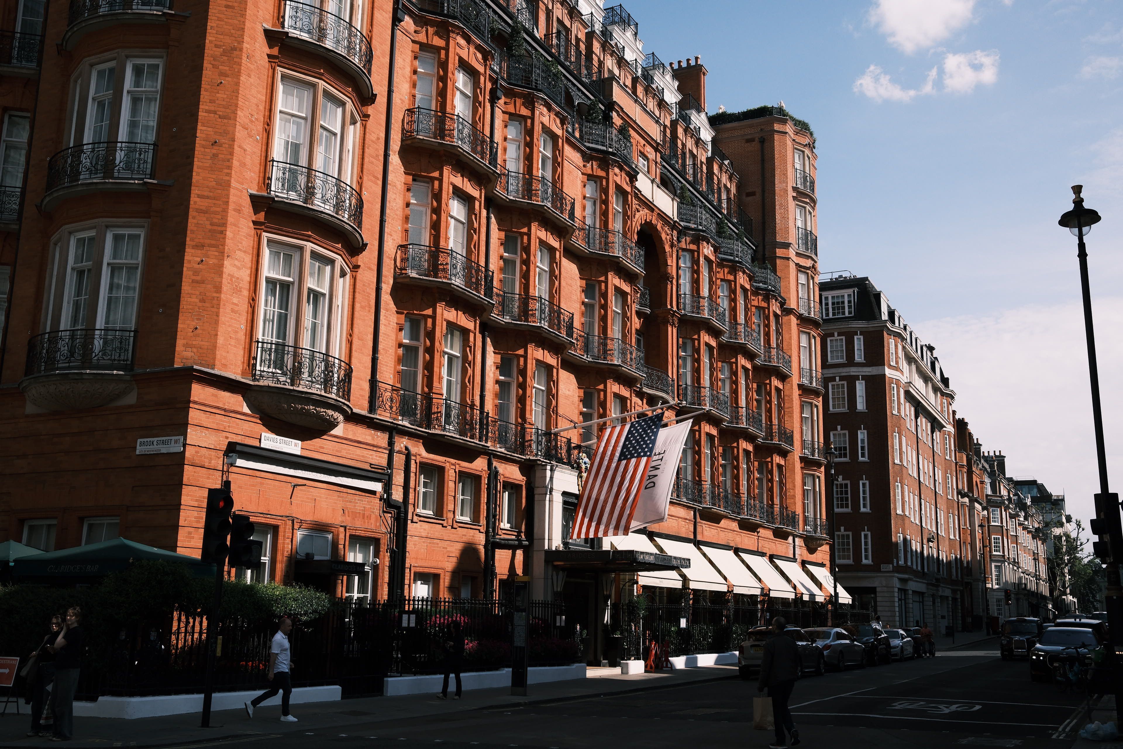 Classic red-brick architecture with flag in central London captures urban elegance in vibrant daylight.