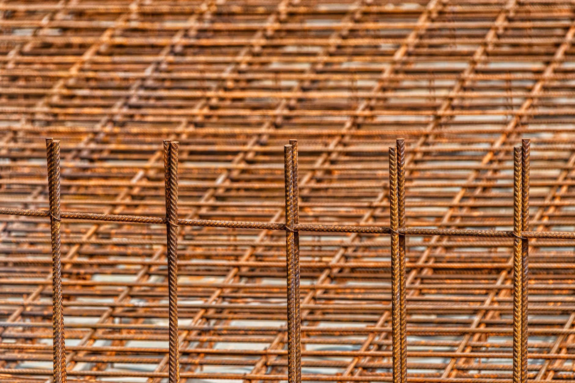 Close-up of a rusty reinforced steel mesh, ideal for construction themes.