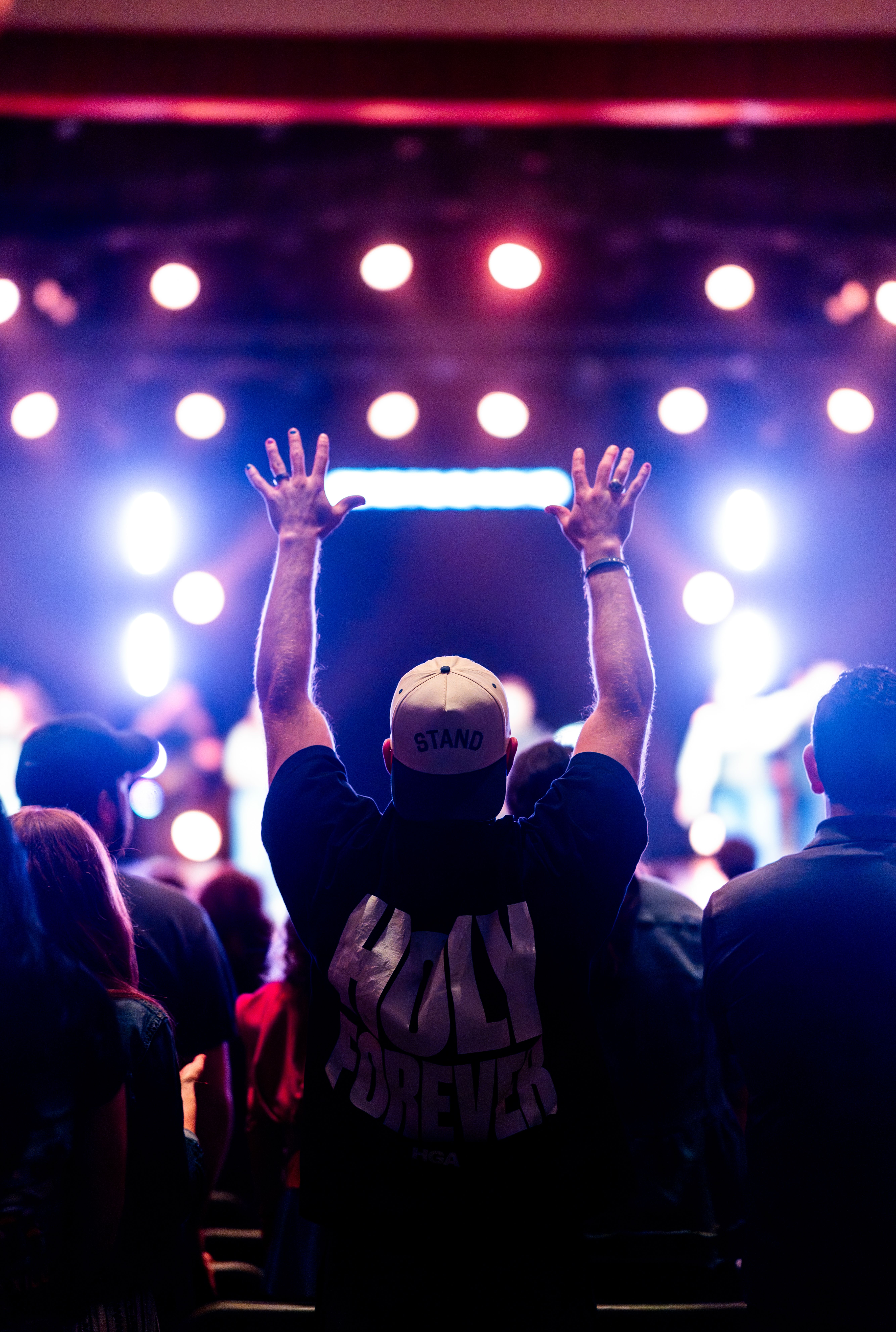 Concert crowd with colourful stage lights for K-pop inspired web design energy