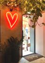 Neon hear sign on shop entrance