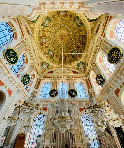Free Decorative mosque interior with intricate dome and chandeliers, showcasing Islamic art. Stock Photo