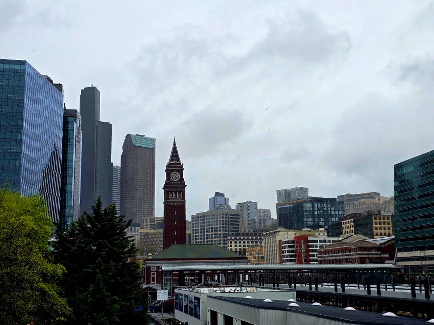 Seattle cityscape view featuring Smith Tower and modern architecture on a cloudy day.