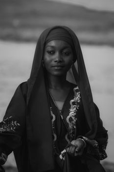 Black and white portrait of a woman wearing traditional dress, exuding grace and elegance.