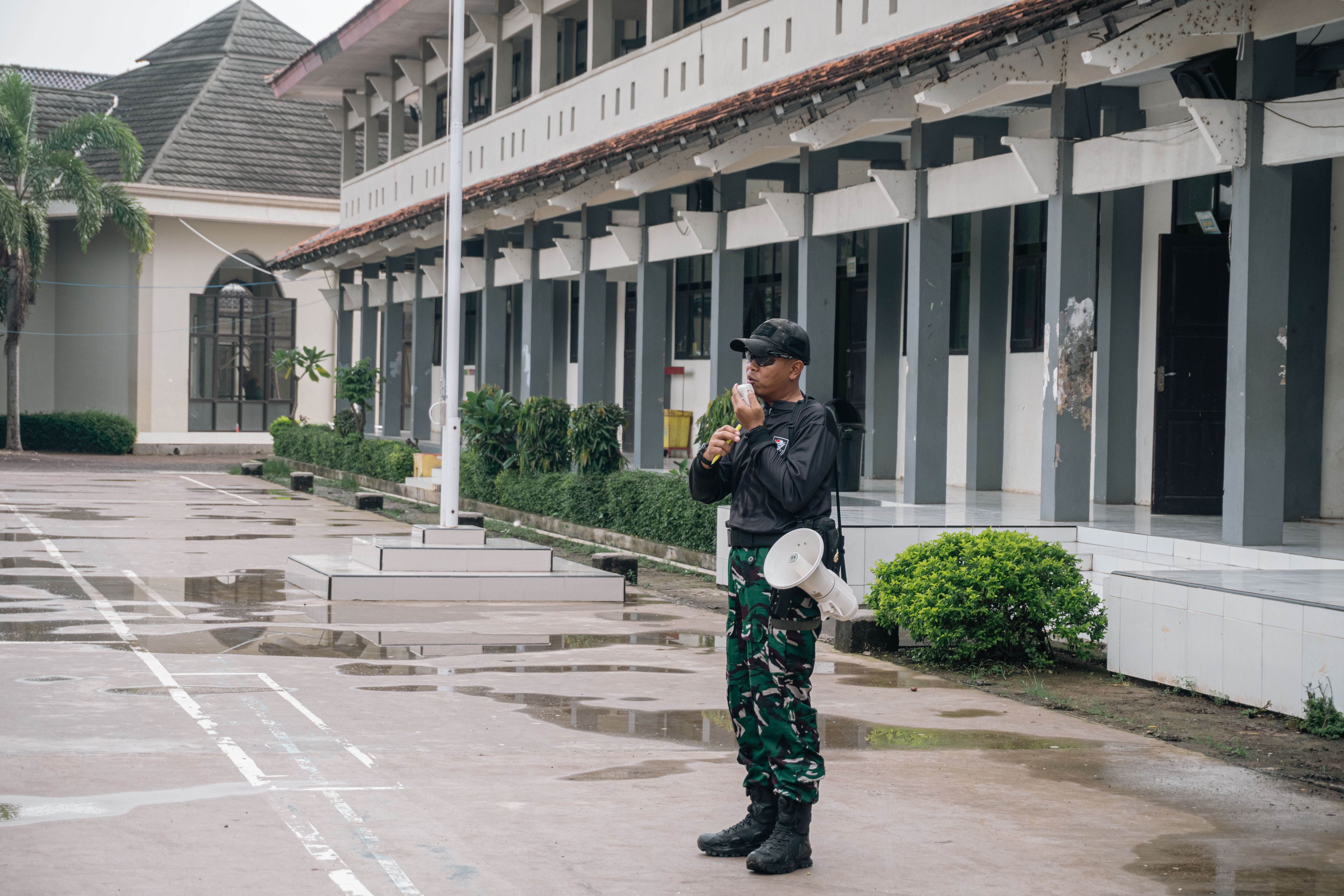 Security Guard with Megaphone on Rainy Day