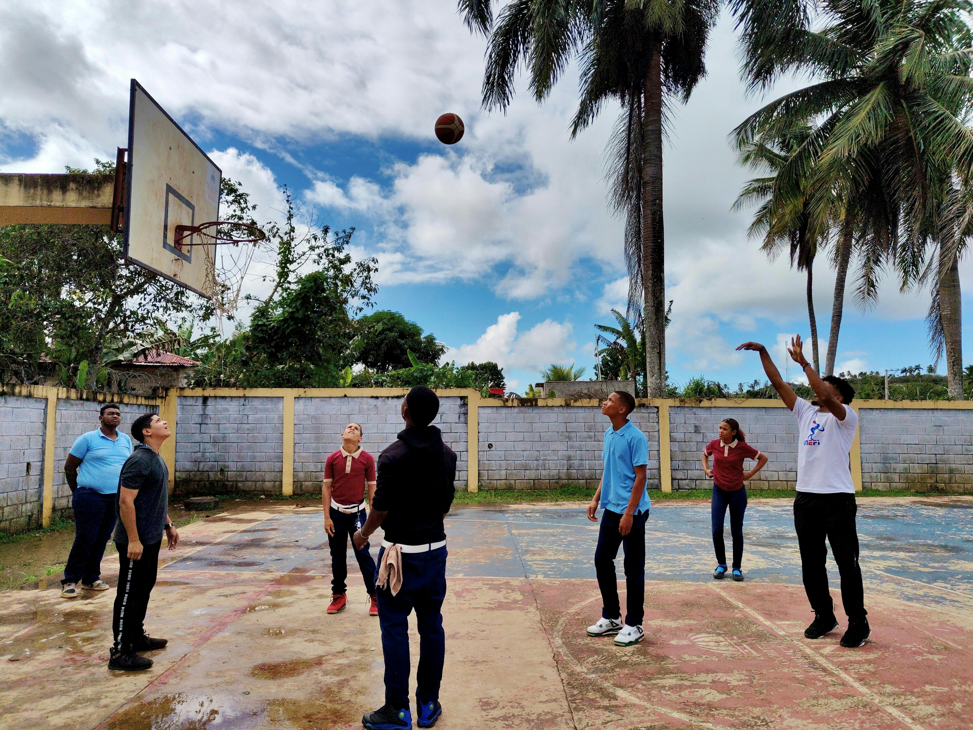 group of people playing basketball at sunset on Christ Embassy court