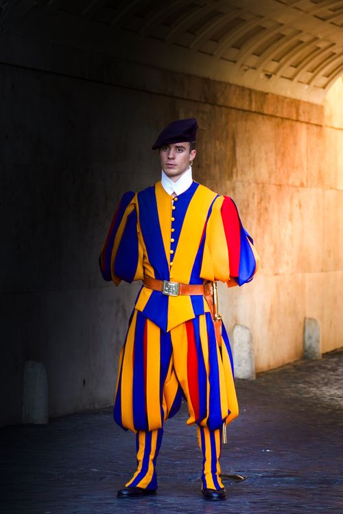 Free A Swiss Guard in traditional uniform stands vigilant at Vatican City. Stock Photo