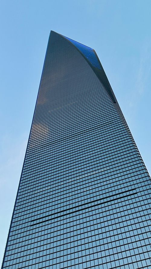 Free Upward view of the Shanghai World Financial Center under a clear blue sky. Stock Photo