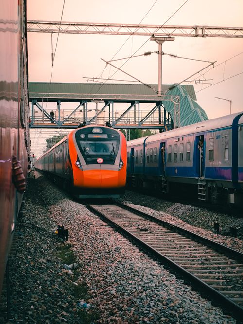 Free A colorful train passes through Anantnag station, showcasing vibrant travel vibes. Stock Photo