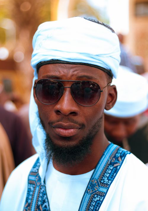 Free A close-up photo capturing a man wearing traditional attire and sunglasses, conveying cultural elegance. Stock Photo