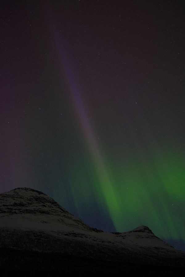 Aurora over a dark ridge line — caleb charles on Pexels