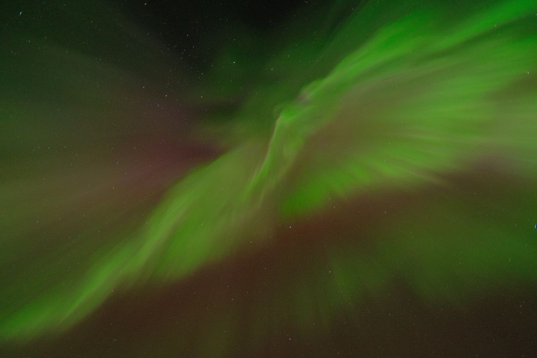 Northern Lights illuminating the winter sky above Tromso Norway