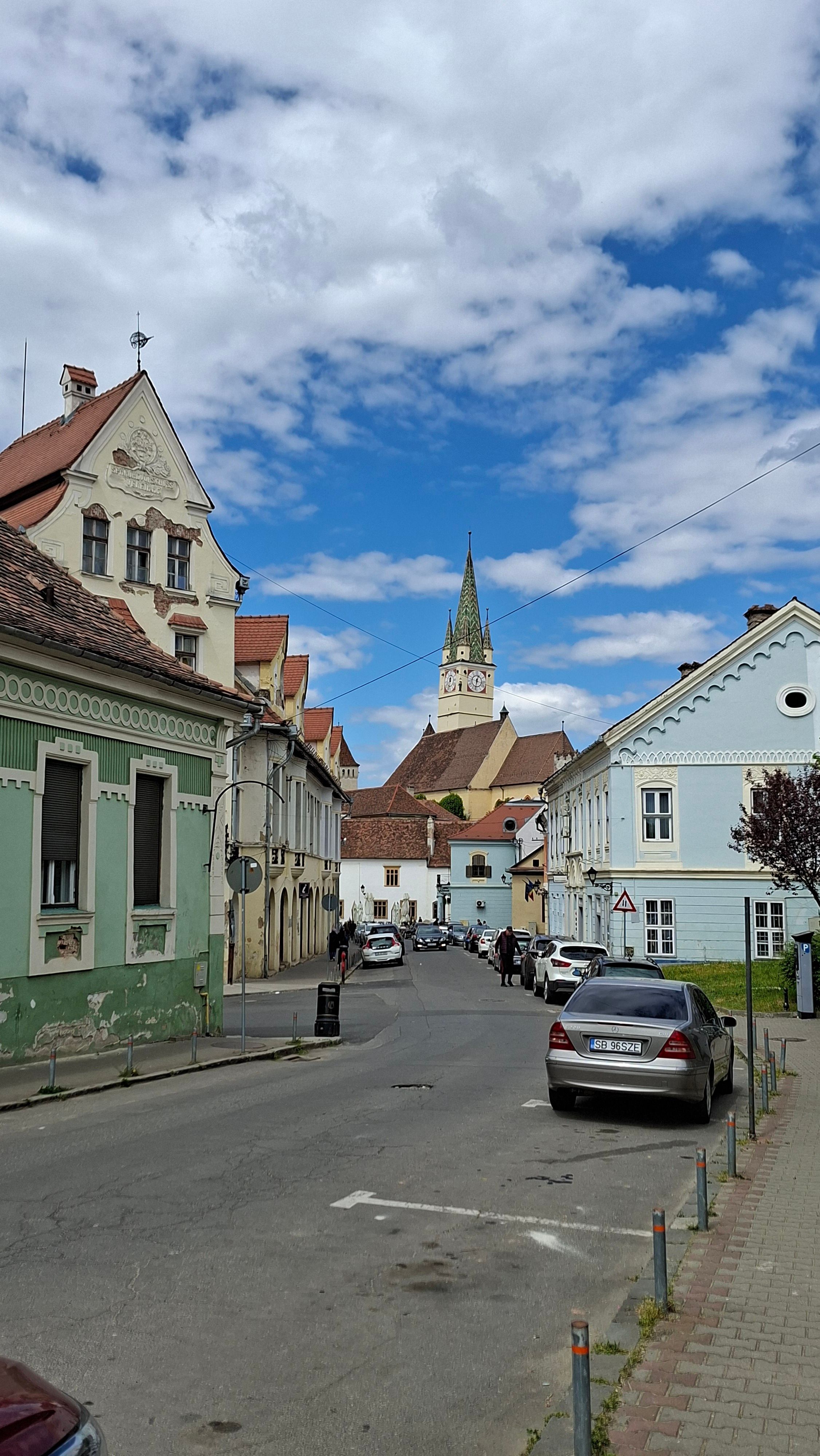 Quaint European street with historic architecture under a blue sky.