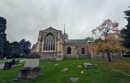 Free A picturesque view of a historic church surrounded by lush greenery in Chelmsford, England. Stock Photo