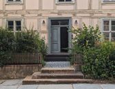 Old-world charm with a rustic doorway and lush greenery. Perfect for architecture enthusiasts.