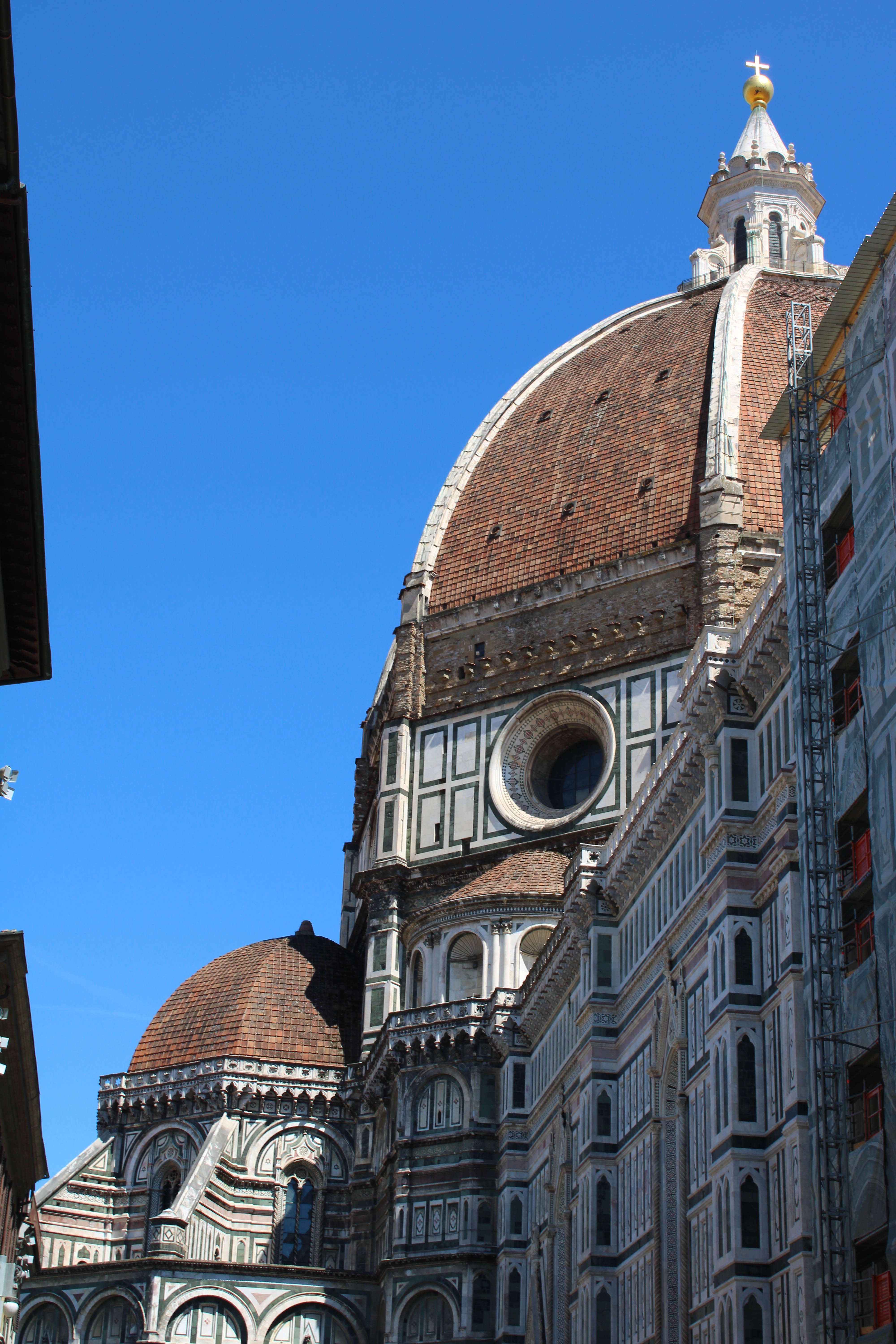 The iconic Florence Cathedral dome beautifully captured under a bright blue sky in Florence, Italy.